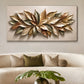 Large rectangular wall art featuring a sculptural metallic leaf design in gold, bronze, and olive tones, displayed above a cream curved sofa in a modern living room.