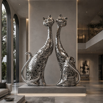 Two metallic cat sculptures in a modern interior setting